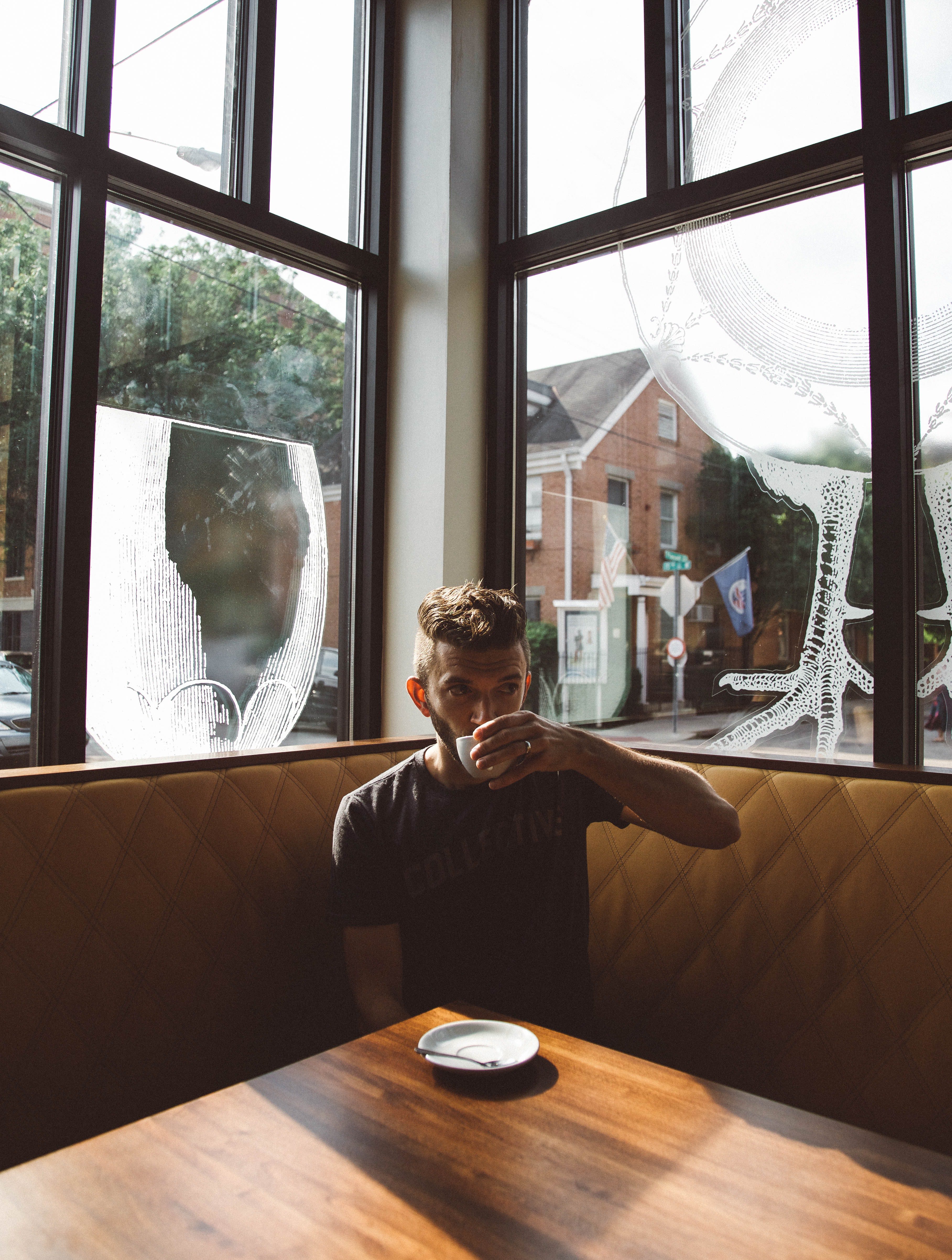 A man drinking coffee in a cafe
